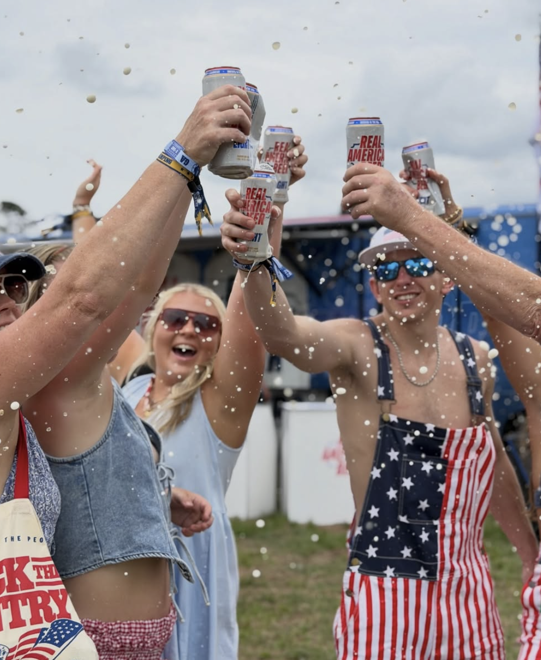 Fans cheers Real American Beer cans at Rock the Country